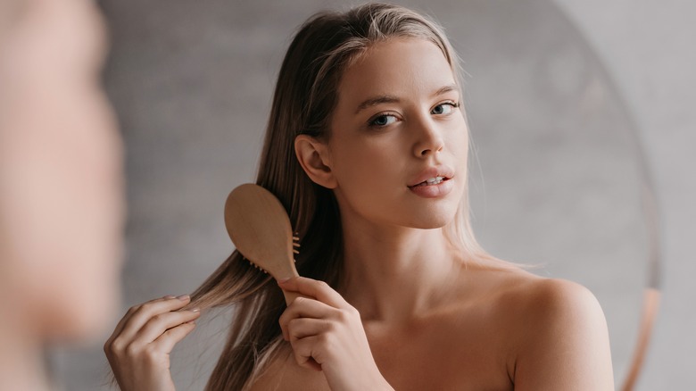 young woman brushing hair 