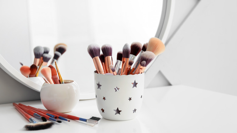 makeup brushes in cups