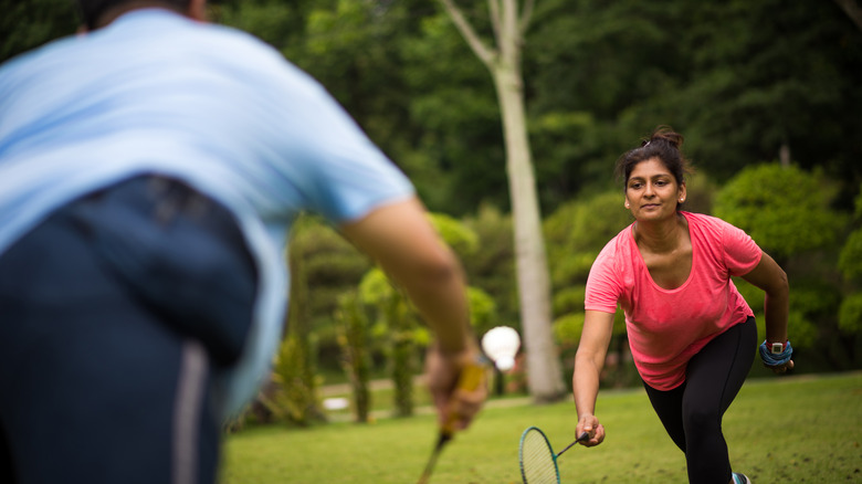 Woman playing badminton outdoors