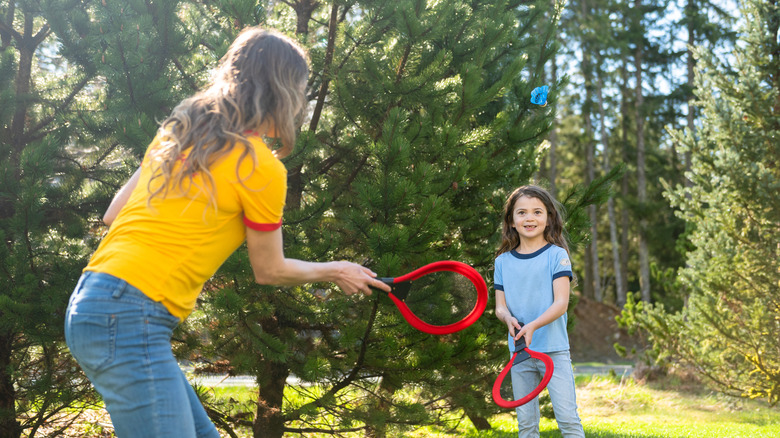 Mother and child playing badminton