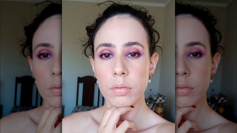 A woman with pink and purple eyeshadow