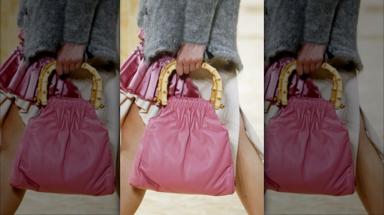 model with pink bag and bamboo handles