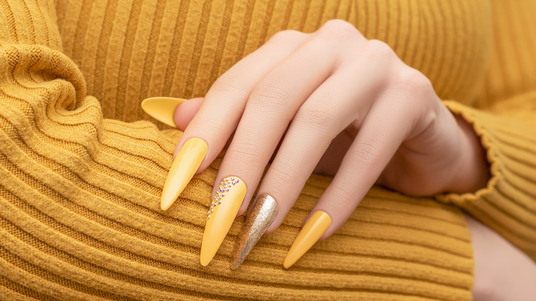 Yellow nails with embellishments