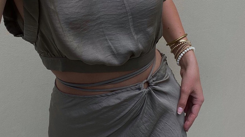 woman wearing stacked bronze jewelry