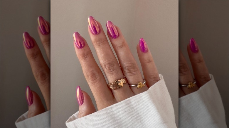 woman with pink chrome nails