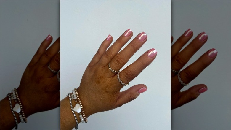 woman with pink chrome nails