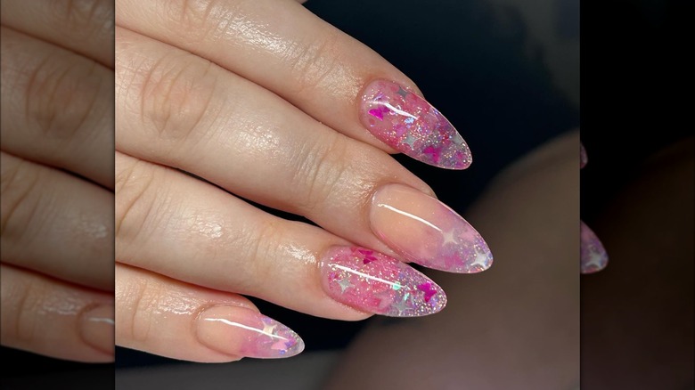 Clear nails with sheer glitter and butterfly cutouts