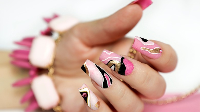 Swirled pink and metallic manicure