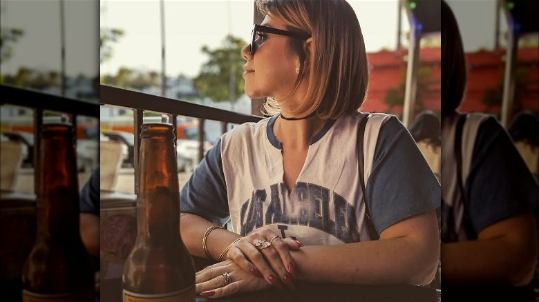 Woman wearing matching jewerly with a baseball jersey