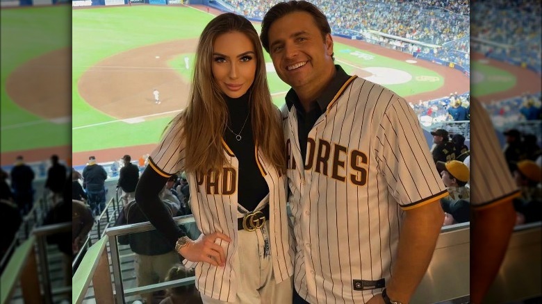 Woman wearing a baseball jersey with a belt