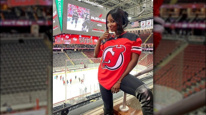 Woman wearing high boots with a baseball jersey