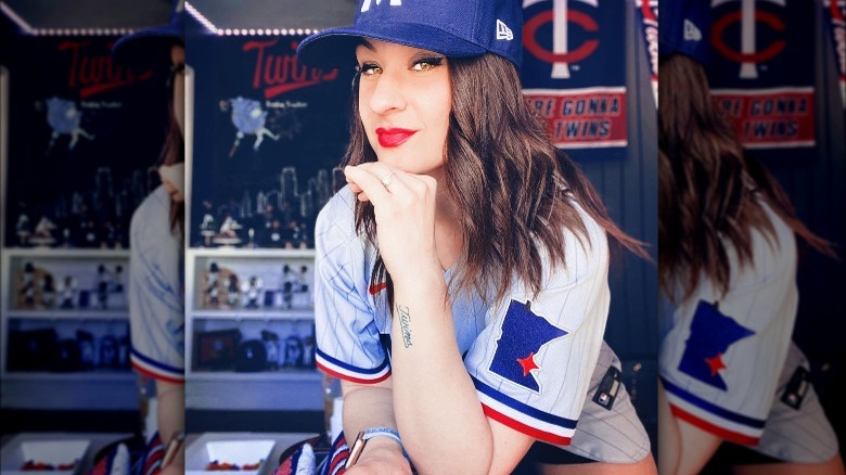 Woman with red lipstick wearing a baseball jersey