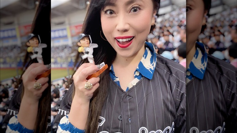 Woman wearing a baseball jersey over a colorful shirt