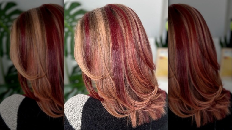 A woman with chunky red highlights