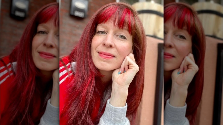 A woman with red highlights on bangs