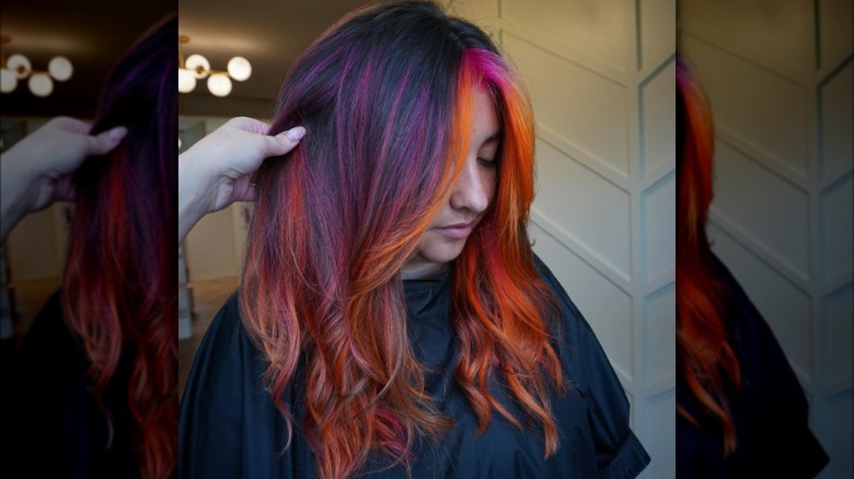 A woman with red and purple highlights