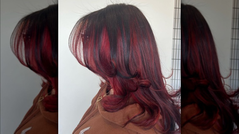 A woman with root shadow red highlights