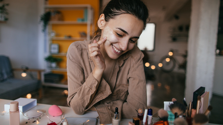 A woman applying makeup