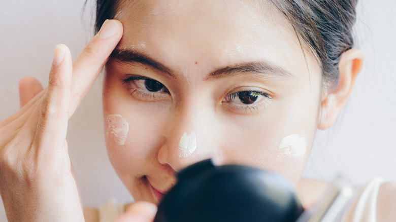 A woman applying makeup