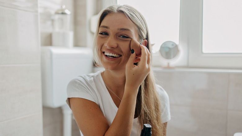 A woman applying makeup