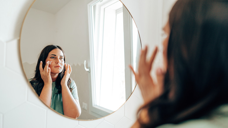 A woman applying makeup