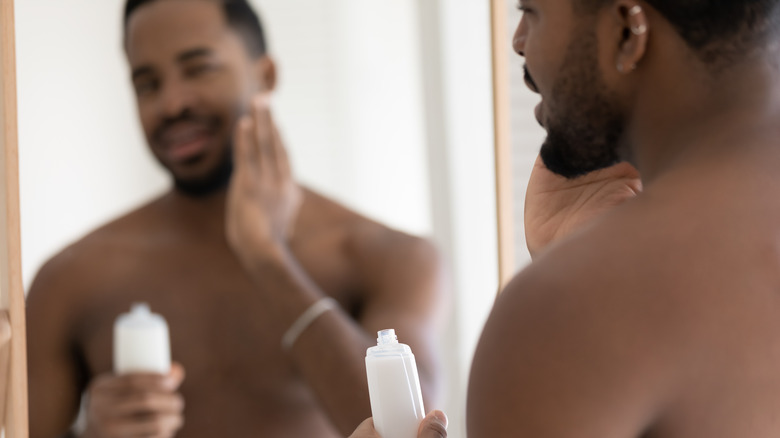 Man applying beard balm