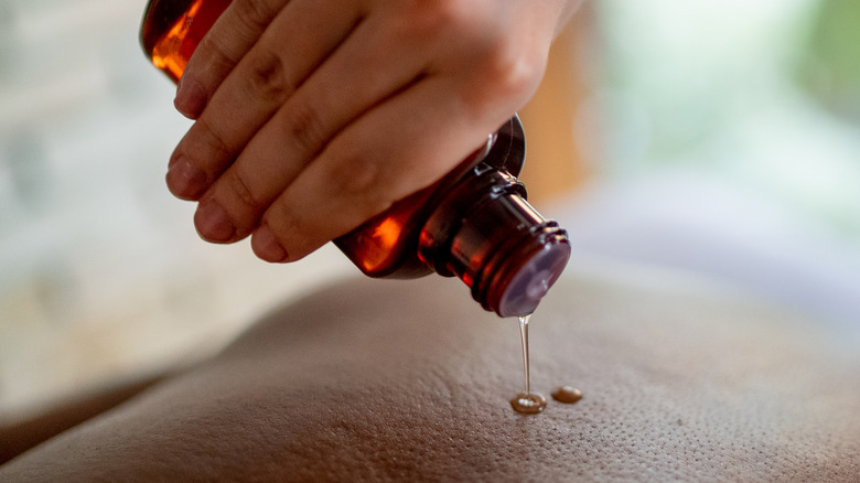 oil being poured on skin