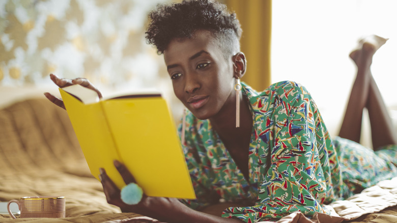 smiling woman reading in bed