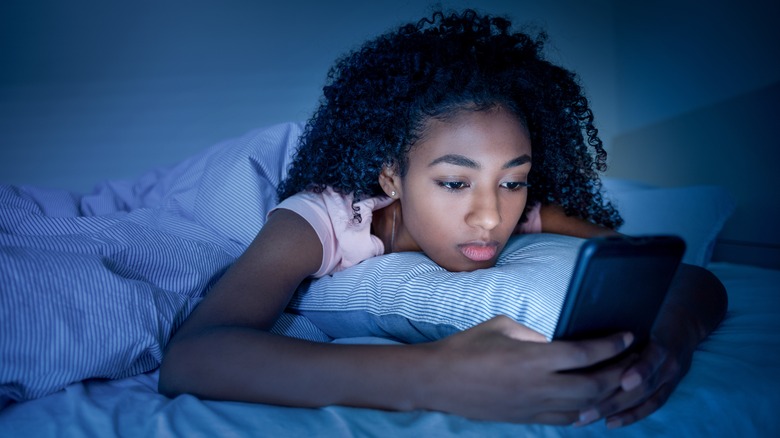 Woman on phone in bed