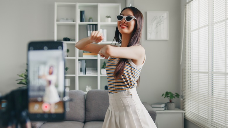 woman creating video with smartphone