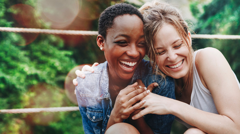 Lesbian couple embracing and laughing