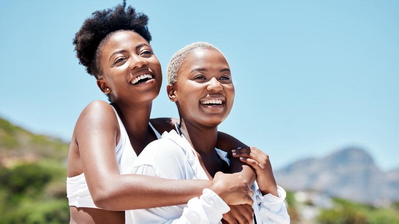 Lesbian couple smiling, embracing