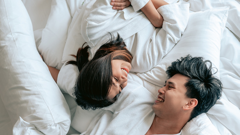 couple smiling in bed
