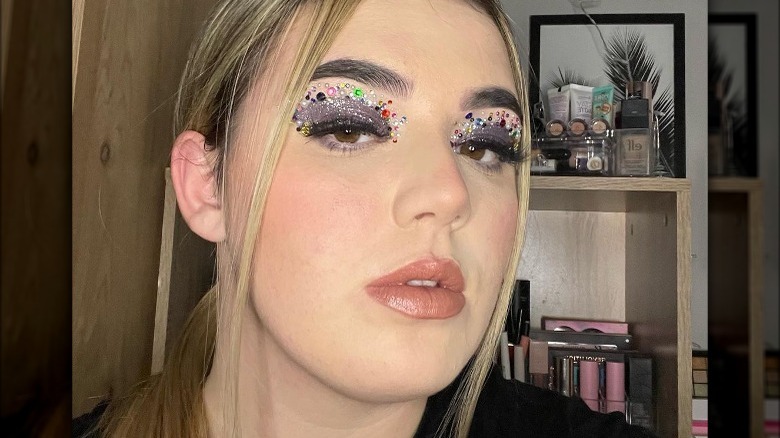 woman with multicolored bejeweled eyelids