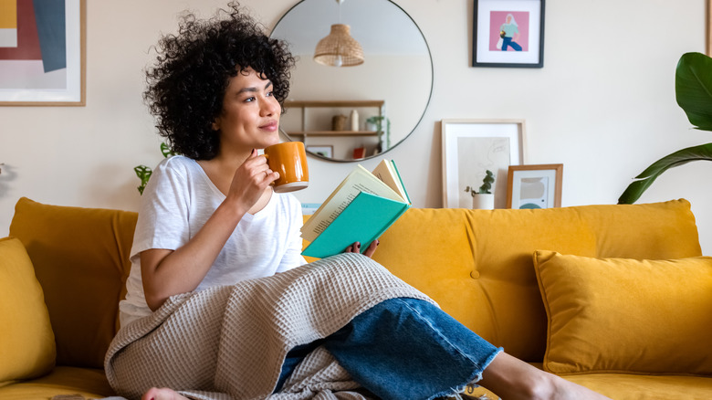 woman drinking tea on couch