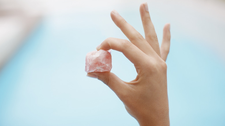 person holding rose quartz