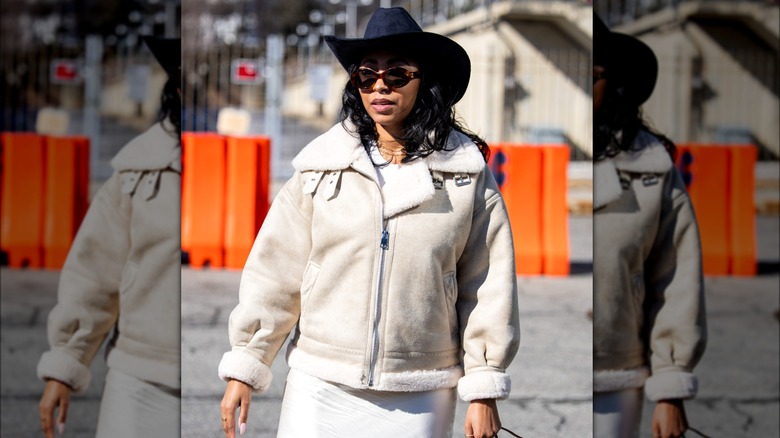 Woman wearing black cowboy hat 