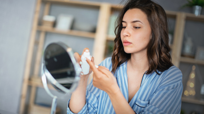 Woman using skincare product