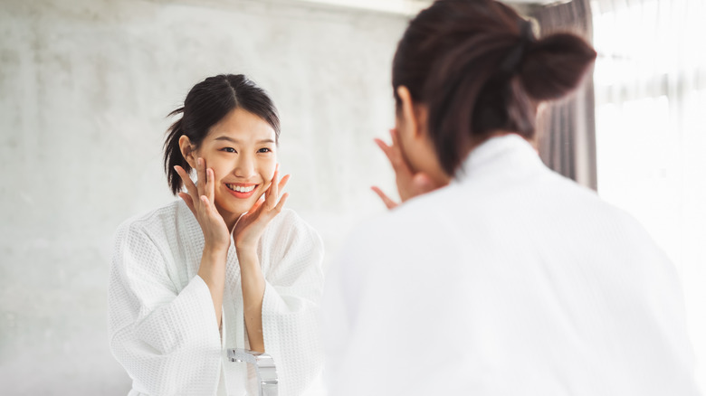 woman applying skincare product