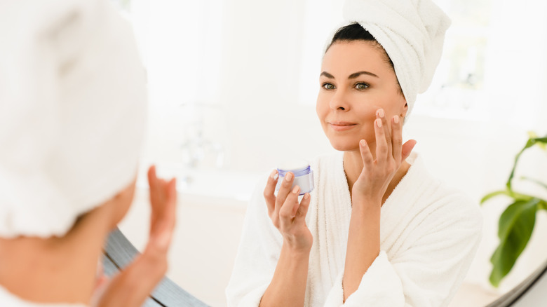 woman applying skincare cream