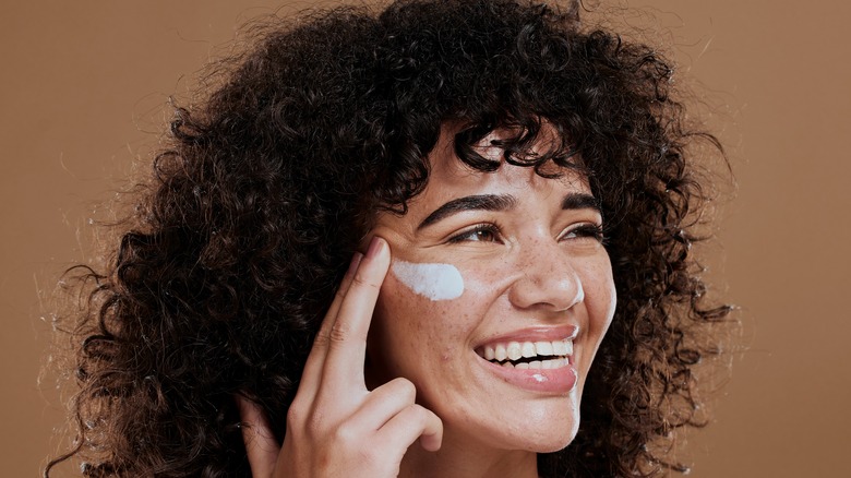 woman applying skincare cream