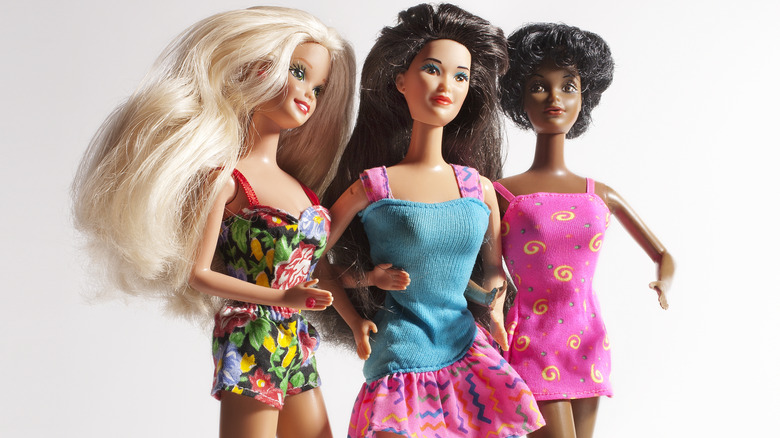 Three Barbie dolls walking