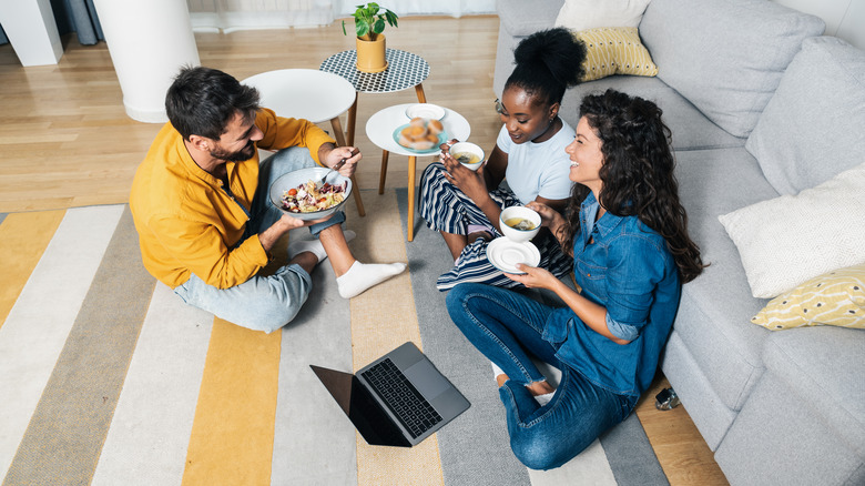 Friends eating on the floor