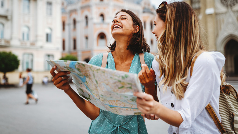 women laughing with map