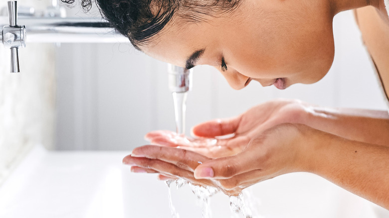 woman washing her face