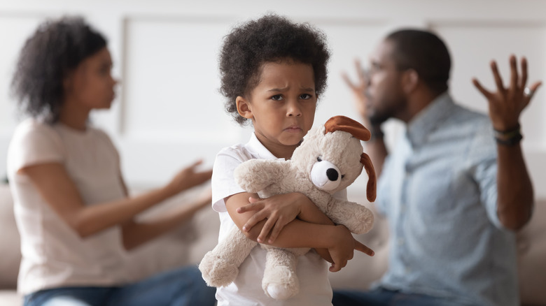 Sad child with fighting parents