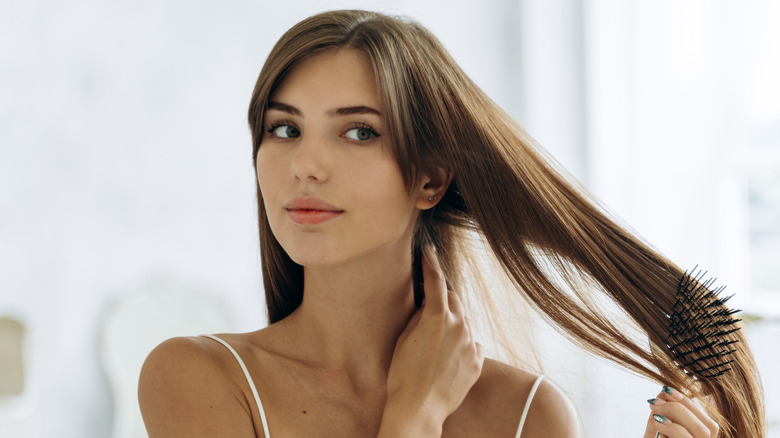 woman brushing brunette hair 