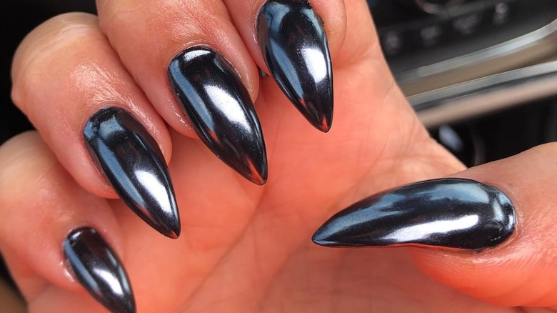 fingers with black chrome nails