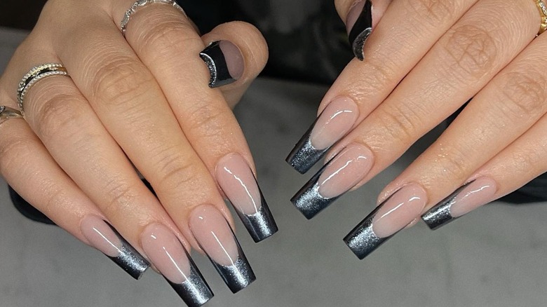 fingers with black chrome nails