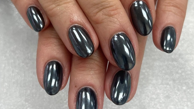 fingers with black chrome nails